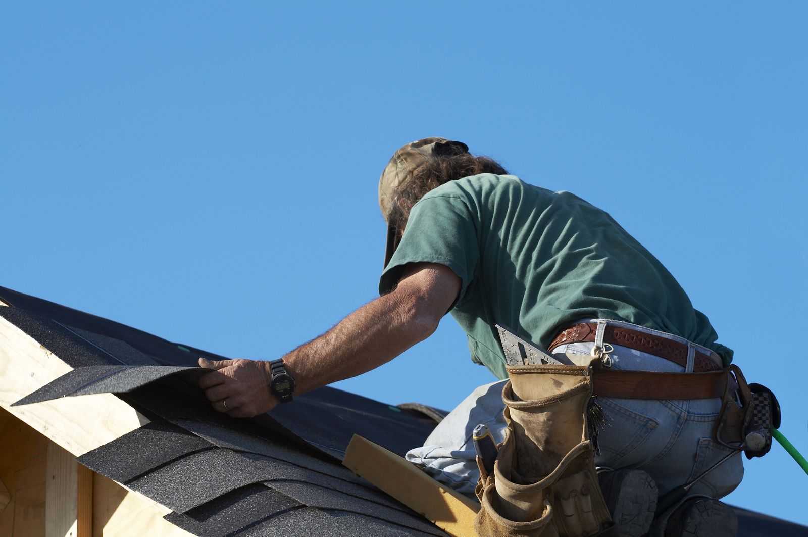 Blackhawk Roofing crew member fastening shingles on a pitched roof in Burr Ridge